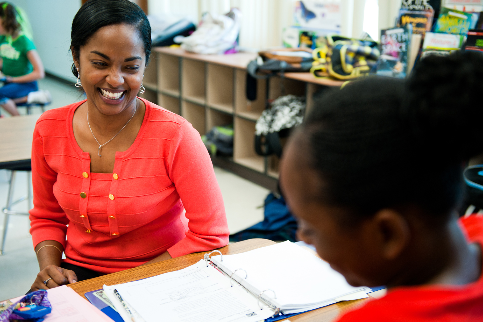 A teacher speaking with a student. 