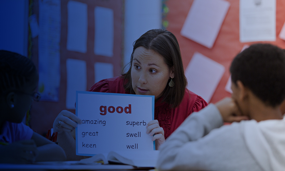 A teacher reading off words to students.