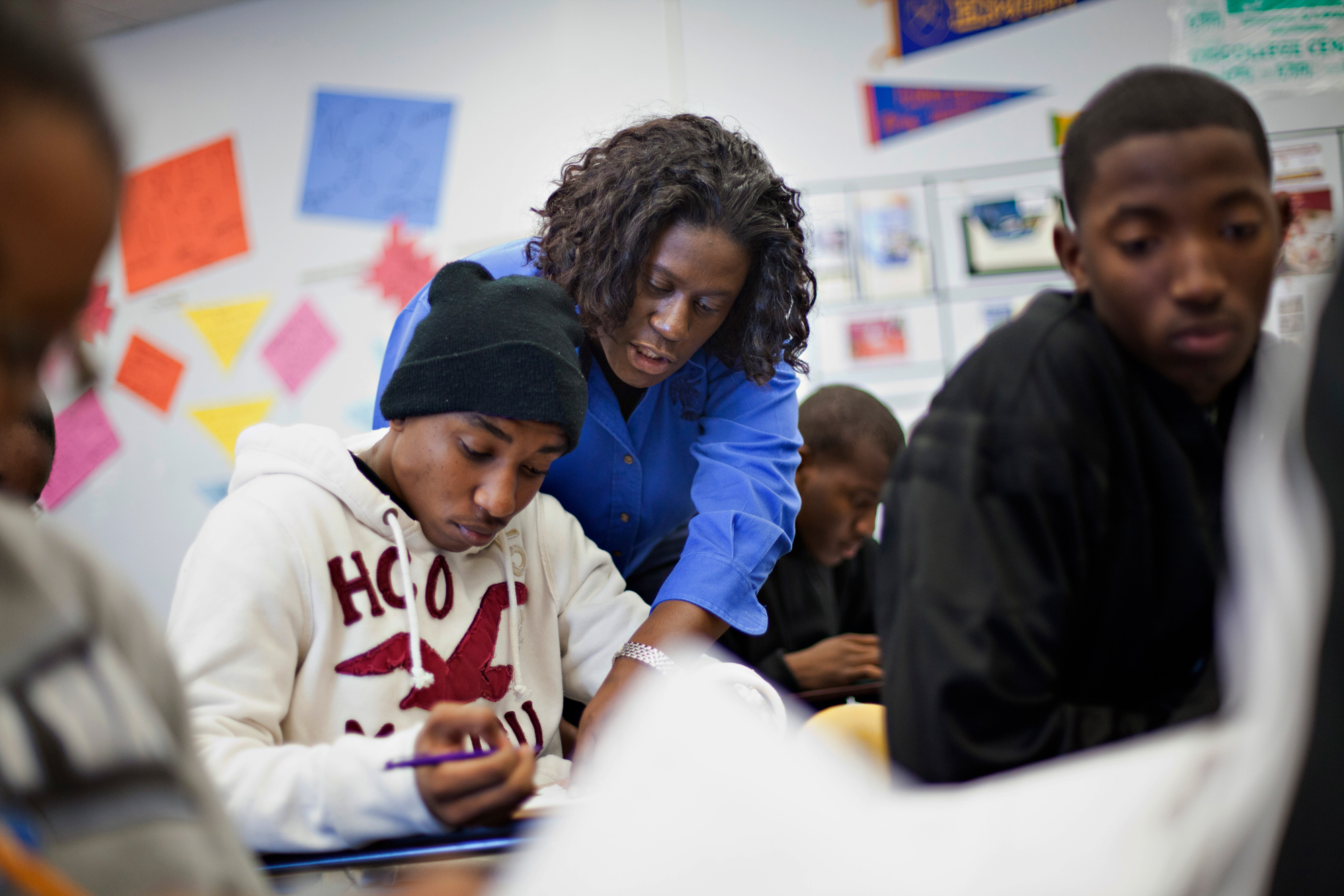 A teacher helping with a student. 